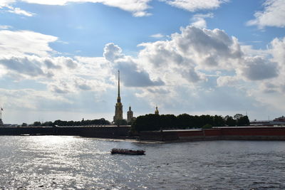 Scenic view of river against cloudy sky