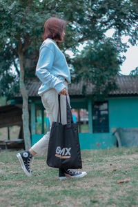 Side view of woman standing on ground