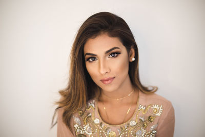 Portrait of a beautiful young woman over white background