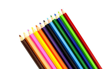 Directly above shot of multi colored pencils against white background