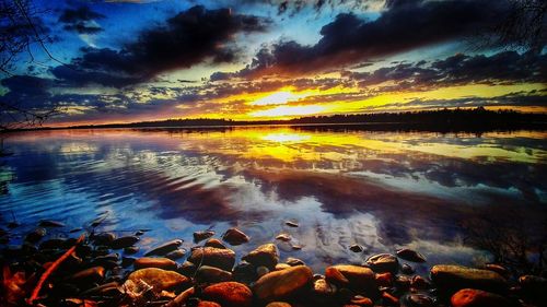 Scenic view of lake against dramatic sky