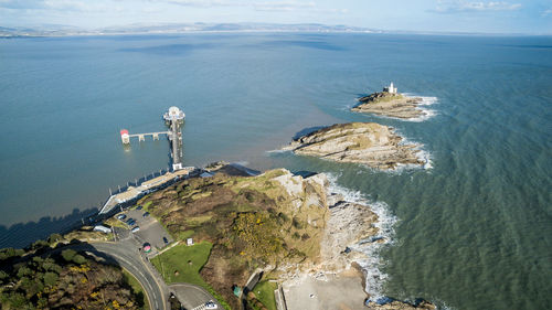 High angle view of cliff by sea against sky