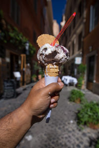 Close-up of hand holding ice cream cone