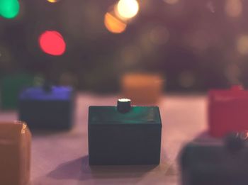 Close-up of illuminated lamp on table in restaurant
