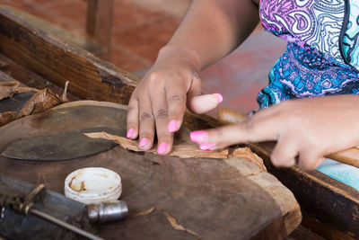 Close-up of woman working on wood at workshop