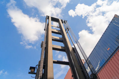 Low angle view of bridge and buildings against sky