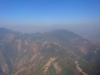 Aerial view of mountain range against clear sky