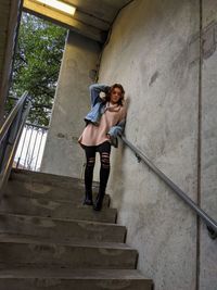 Low angle view of woman on staircase