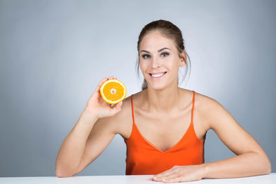 Portrait of a smiling young woman against white background