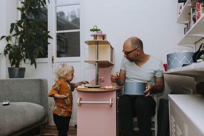 Father and toddler playing together