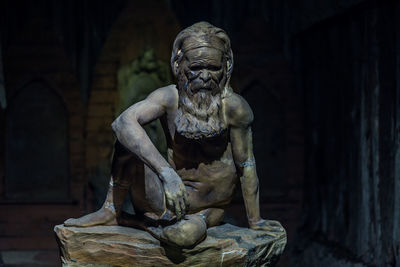 Statue against stone wall