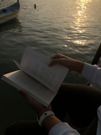 High angle view of hand holding book