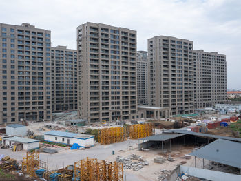 High angle view of buildings in city against sky