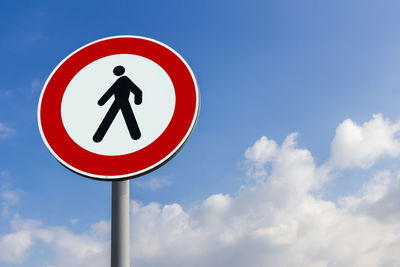 Low angle view of road sign against sky