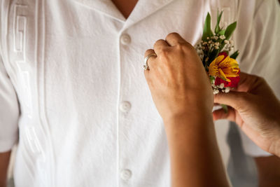 Midsection of woman holding flower bouquet