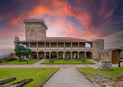 View of old building against sky during sunset