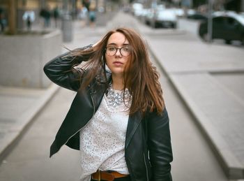 Beautiful young woman on street in city
