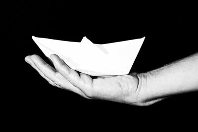 Close-up of hand holding glass over white background