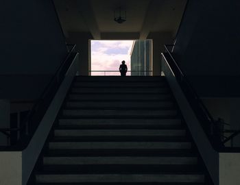 Low angle view of silhouette woman walking on stairs