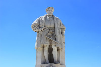 Low angle view of statue against clear blue sky