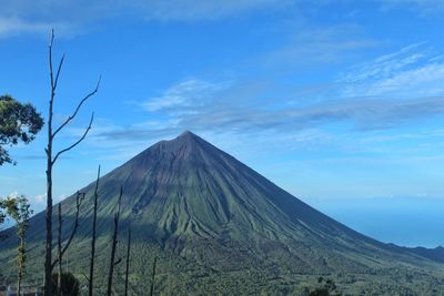 View of volcanic mountain against cloudy sky