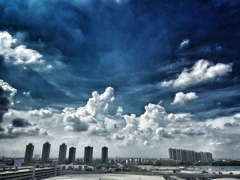 Crowd on sea against sky