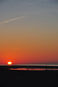 Scenic view of sea against orange sky