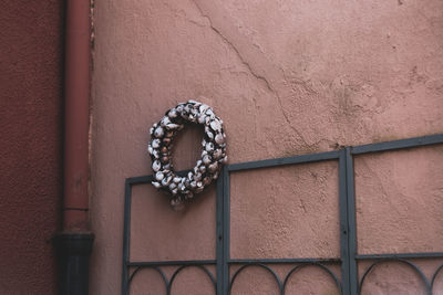 Low angle view of metal hanging on wall