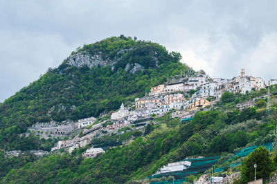 Buildings in town against sky