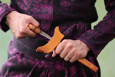 Midsection of man holding knife