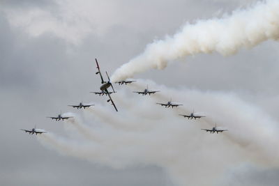 Low angle view of airshow against sky