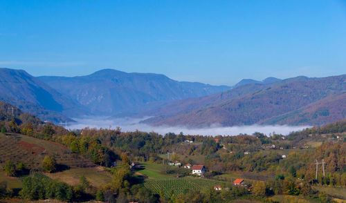 Scenic view of mountains against clear blue sky