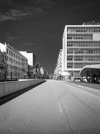 Surface level of road by buildings against sky