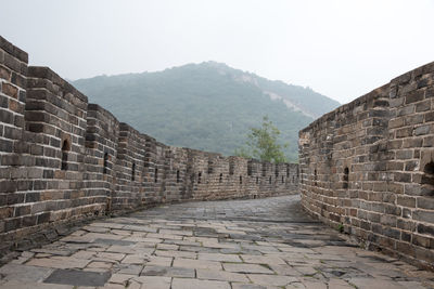 View of brick wall with mountain in background