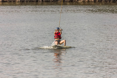 Man kite boarding in river