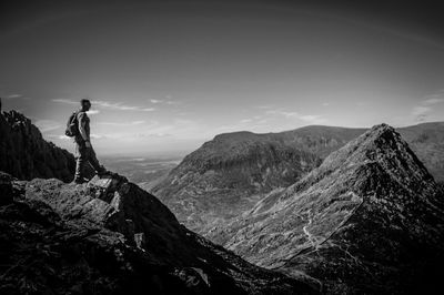 Man looking at mountain against sky