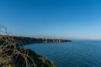 Scenic view of sea against clear blue sky