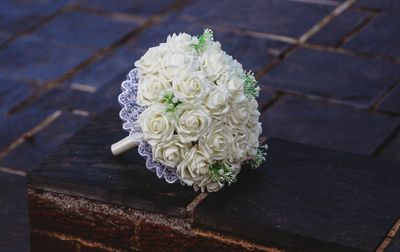 Close-up of white rose on wood