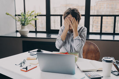 Young woman using laptop at office