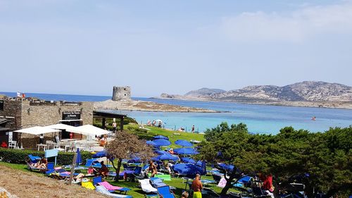 People on beach against sky