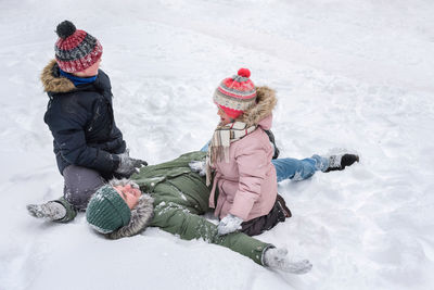 High angle view of woman skiing on snow covered field