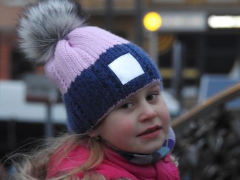 Close-up portrait of cute girl wearing knit hat