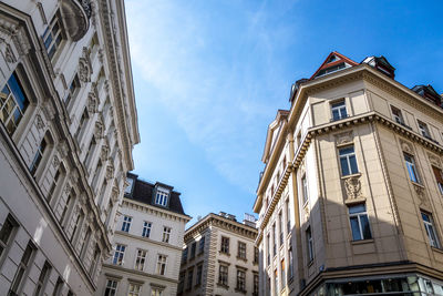 Low angle view of buildings in town against sky