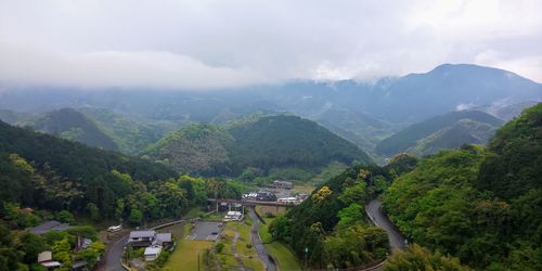 Scenic view of trees and mountains against sky