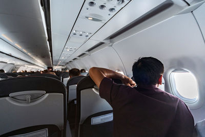 Rear view of people sitting in airplane