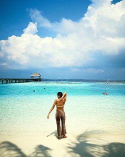 Full length rear view of man standing on beach