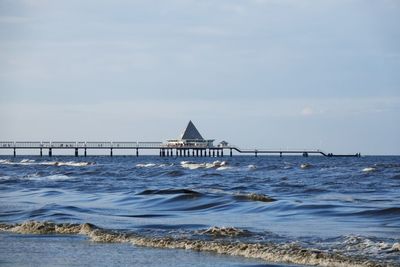 Pier and sea against sky