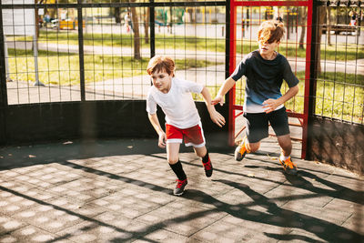 Brothers running in playground