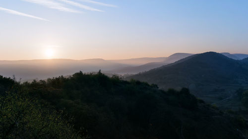 Scenic view of mountains against sky during sunset