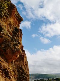 Low angle view of rock formation against sky